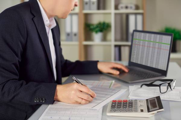 A Flowbe consultant discusses an IT audit and assessment report with a business executive in the UAE.